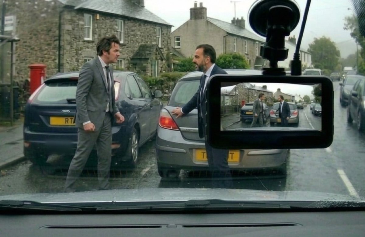 Two men in a road rage confrontation on a rainy UK street, captured by dashcam